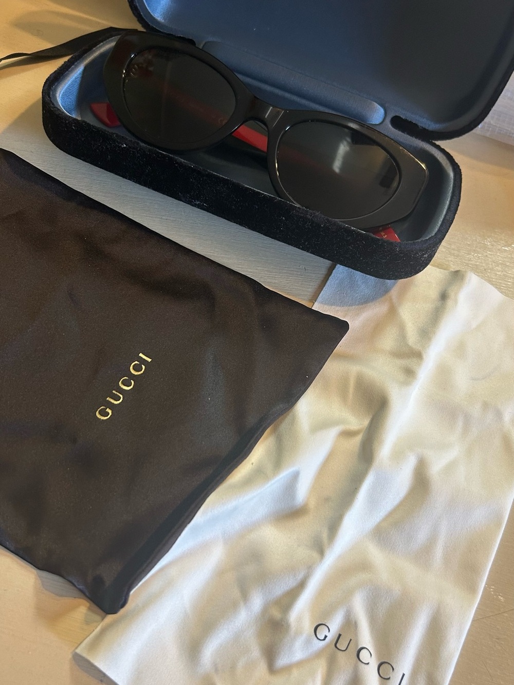 Gucci women’s Black Sunglasses with Red Temple Details